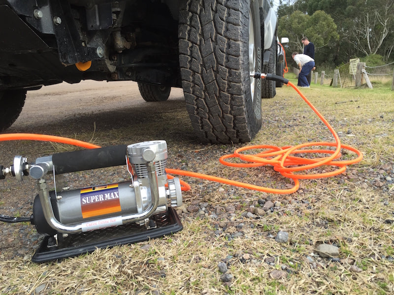 Checking 4x4 tyre pressure with a gauge