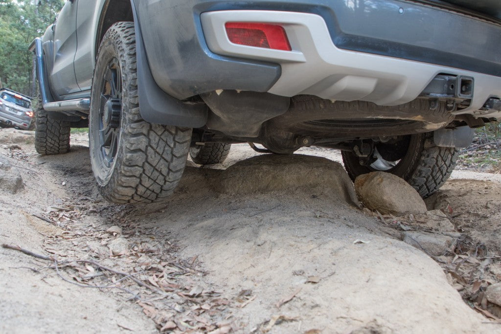 Underside of a 4x4 showing diff clearance over an obstacle